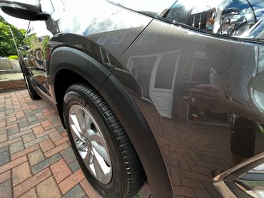Front 3/4 of grey Hyundai Tuscon with restored shine after valet by AM Auto Aesthetics
