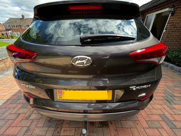 Rear of grey Hyundai Tuscon with boot gloss and clean exhaust finish