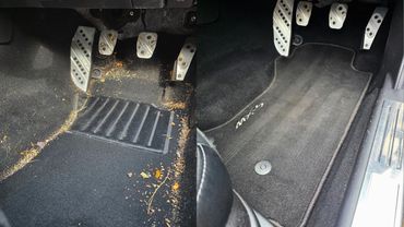 Side by side before and after images showing the drivers footwell detailed by AM Auto Aesthetics