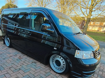 Front 3/4 of black VW Transporter with restored shine after valet by AM Auto Aesthetics