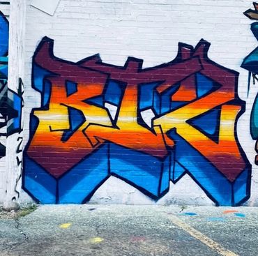 Bold 3D graffiti in vibrant sunset colors with sharp letter styling—urban street art in Columbus