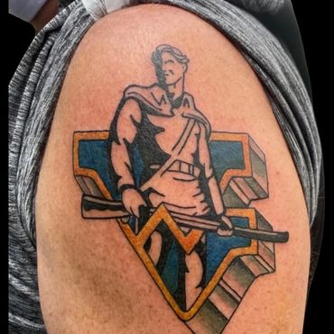 Bold West Virginia Mountaineer tattoo with 3D WV logo — Done at Stoic Body Art in Columbus, Ohio.
a