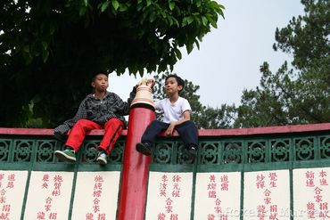 Two boys sit on a fence at Bell Church in Baguio. 