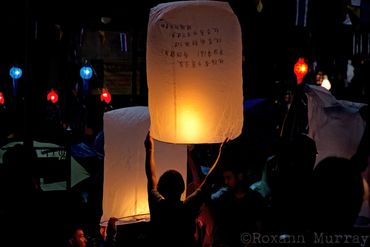 A woman gets ready to release her lantern at a Loi Krathong festival in Chiang Mai.