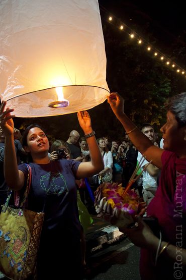 A woman prepares to let go of her paper lantern during Loi Krathong in Chiang Mai.