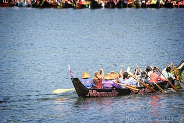 Nisqually Tribal members paddle their canoe in the Port of Olympia during Canoe Journey.