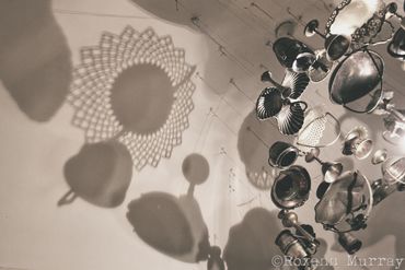 Hanging silver dishes and their shadows