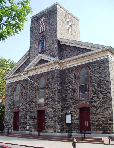 Old stone church with stained glass windows.