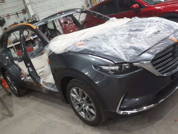 grey car being crash repaired workshop