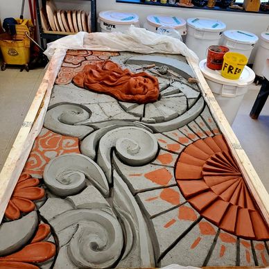 Depicted is the completion of the carving and modeling for the clay relief mural. 