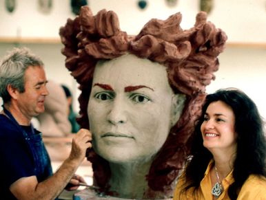 Ceramic artist Koschetzki working on a clay portrait head of Laurel Lee