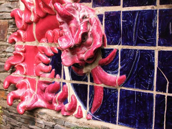 Closeup detail of red dragon 3D relief wall sculpture