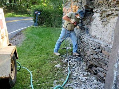 Removing the old frost damaged clay art  mural