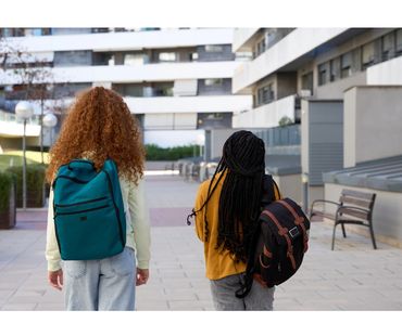 Emergency childcare service picking children up from school for families.