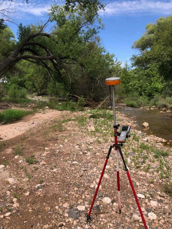 survey tools next to a river