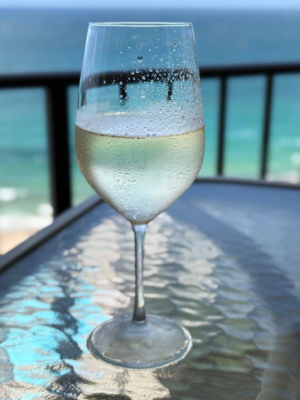 Wine glass on table with condensation.