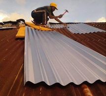 Carpenter replacing damaged roof panels/zinc and combing