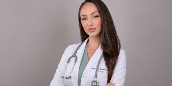 Confident female doctor in a white coat with a stethoscope around her neck.