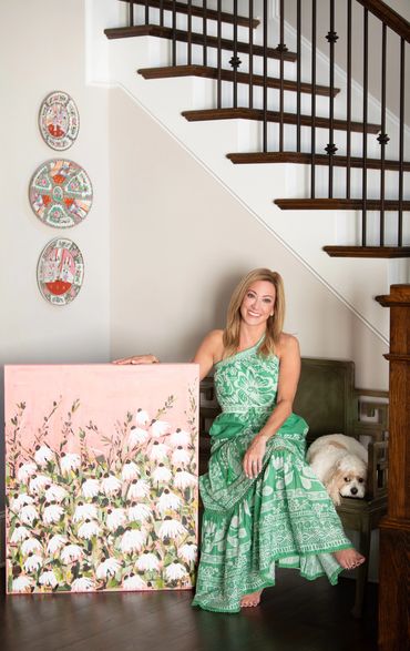 artist sitting with her art pieces