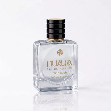 Clear glass perfume bottle with black and gold cap labeled NuAura Rose Bush.