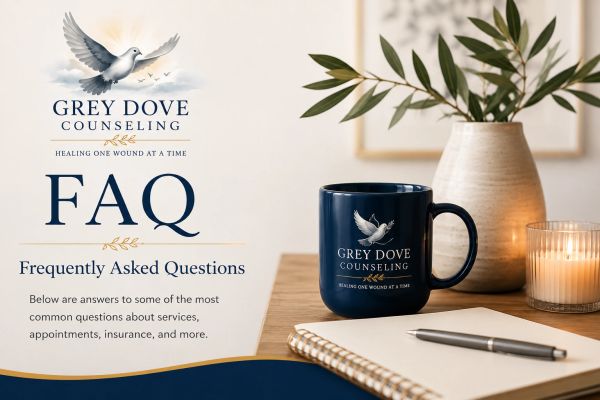 Grey Dove Counseling FAQ with a calming desk setup including a mug, notebook, and plant.