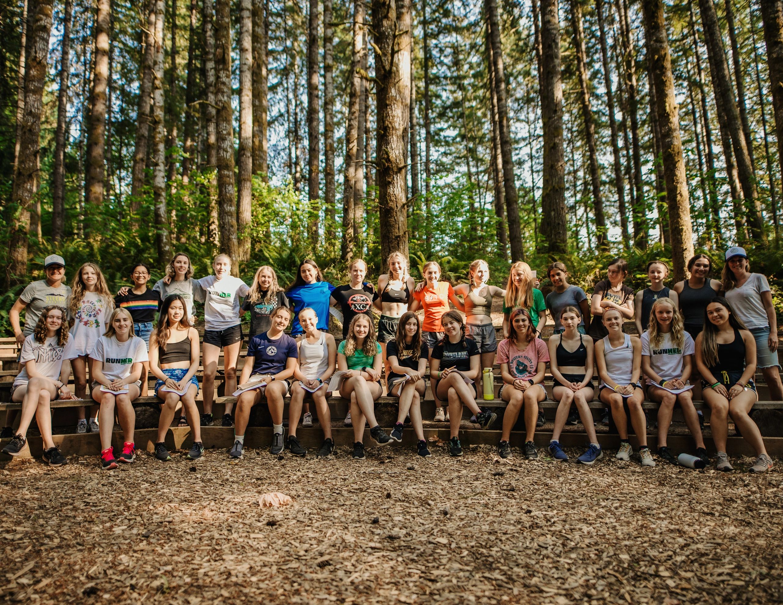 Group of high school runners smiling at cross country camp