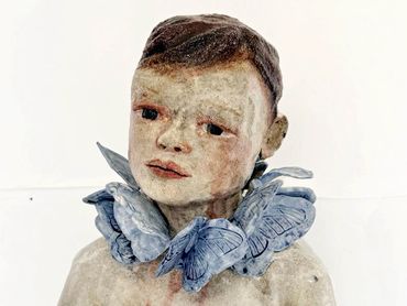 BOY WITH BUTTERFLIES
12” x 11 ½” x 6”
2024
Clay, underglaze, Nichrome Wire.