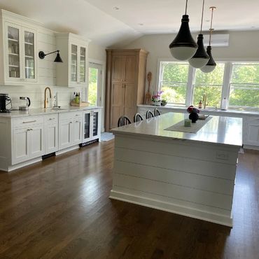 Modern interior design in Newport kitchen featuring white shaker cabinets, quartz island, and design