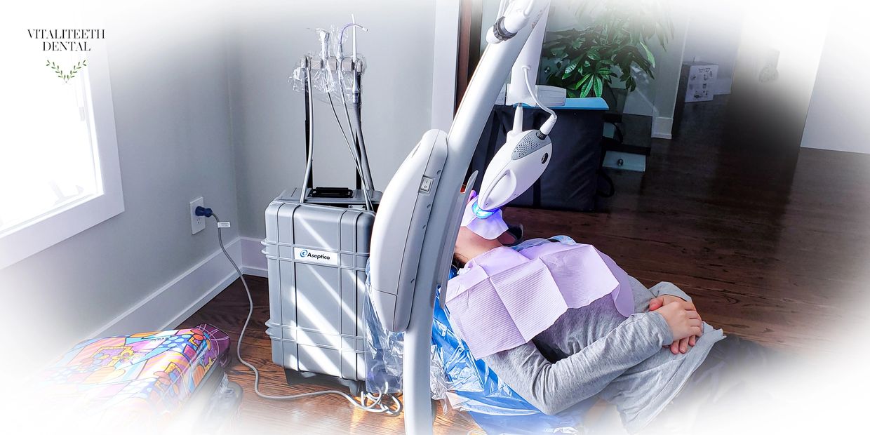 Philips Zoom laser lamp to woman on mobile chair at home by Monica Cordova of VitaliTeeth Dental