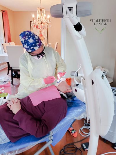 mobile dental hygienist Monica Cordova doing dental cleaning on man VitaliTeeth Dental