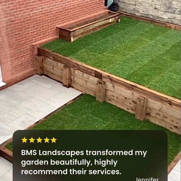 Newly landscaped garden with turf and wooden borders.