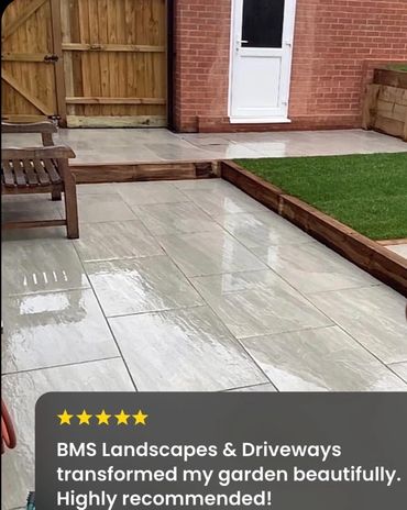 Freshly landscaped garden with clean tiled patios and wooden edges.
