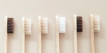 Various bamboo toothbrushes with different bristle colors.