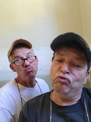 Two men making funny duck faces.