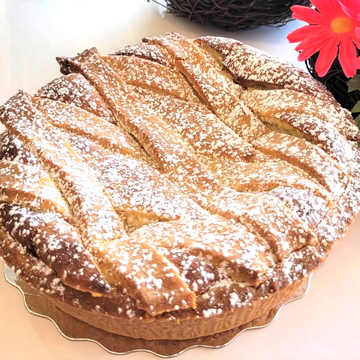 Golden lattice crust pie dusted with powdered sugar.