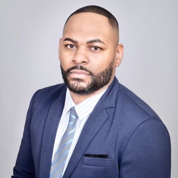 Professional man in a blue suit and striped tie.