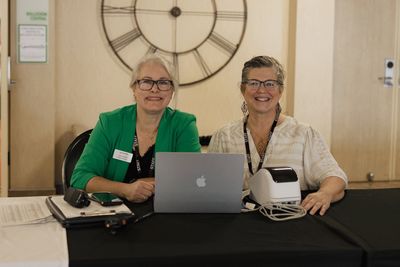 Lisa Fitzgerald and Lynn Nichols managing a ministry event.