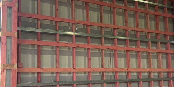 Wooden framework with a circular saw on a bench in a workshop.