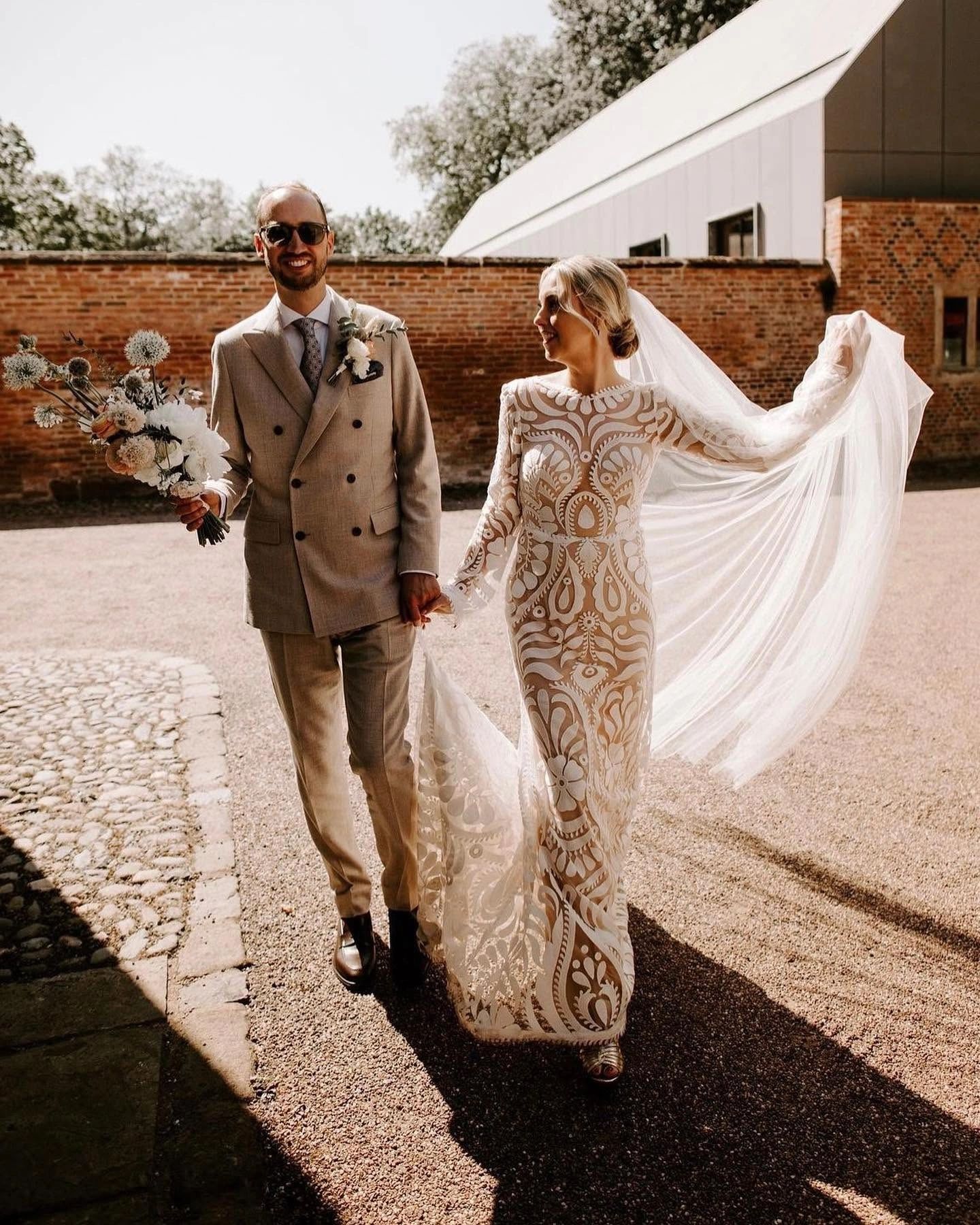Bride and groom holding hands on their wedding day.