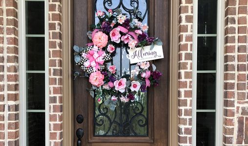 Alluring Wreath Designs Logo Wreath on the front door of the shop.