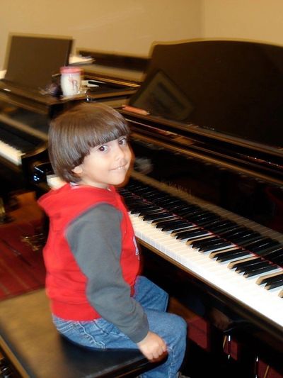 3 year old at Suzuki piano lesson with two grand pianos