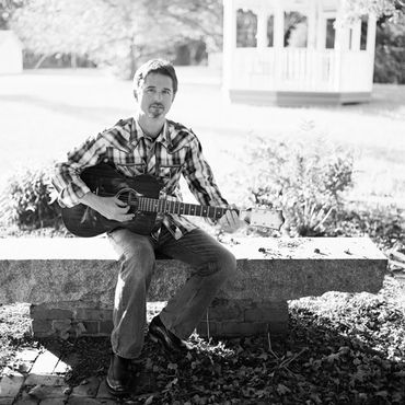 Black and White photo of Timothy Scott Williams with guitar