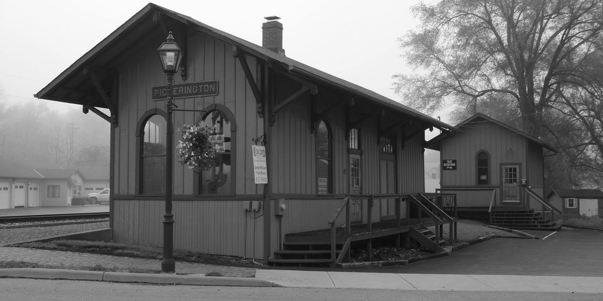 Historic Pickerington train station building in black and white.