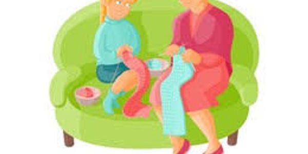 Older woman and girl knitting on a couch.