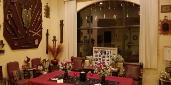 Elegant dining room with classic armchairs and floral decorations.
