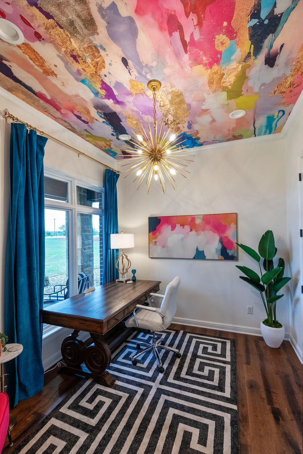 Colorful ceiling with gold accents in a stylish home office.