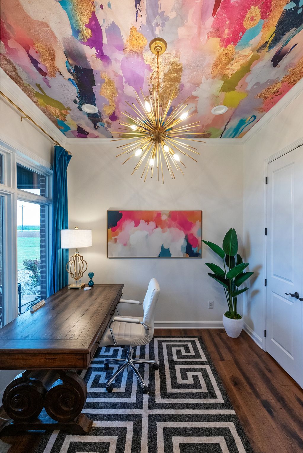 Vibrant home office with colorful ceiling and modern decor.