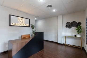 Modern reception area of Allen Law Firm with sleek desk and minimalist decor.