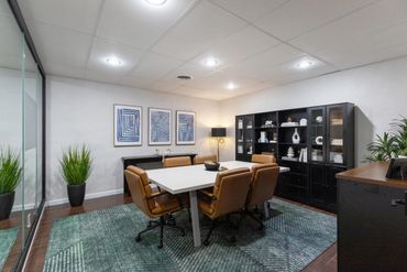 Modern conference room with glass walls and stylish furniture.