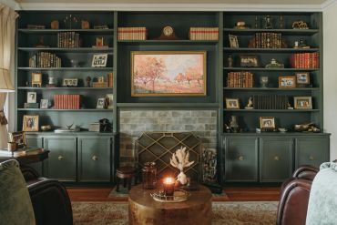 Cozy living room with built-in bookshelves and a fireplace.